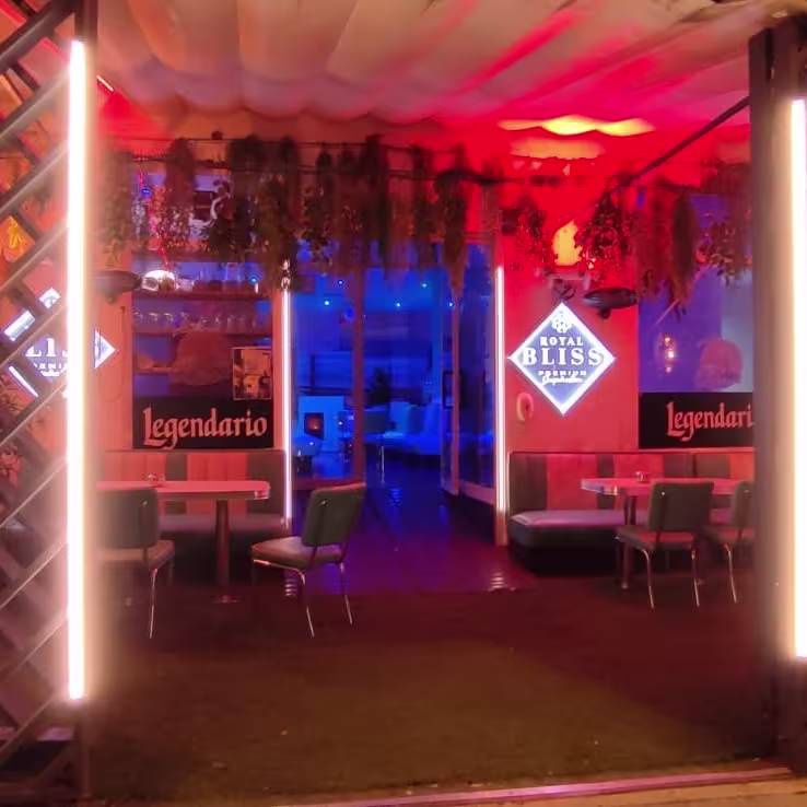 El Palmar Montequinto presenta una entrada iluminada con tonos cálidos y detalles de madera, invitando a disfrutar de su acogedor interior.