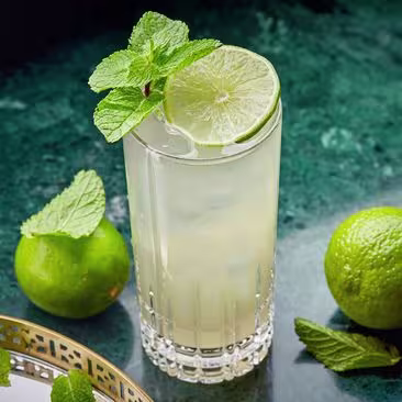 A Long Vodka served in a tall glass and garnished with lime and mint