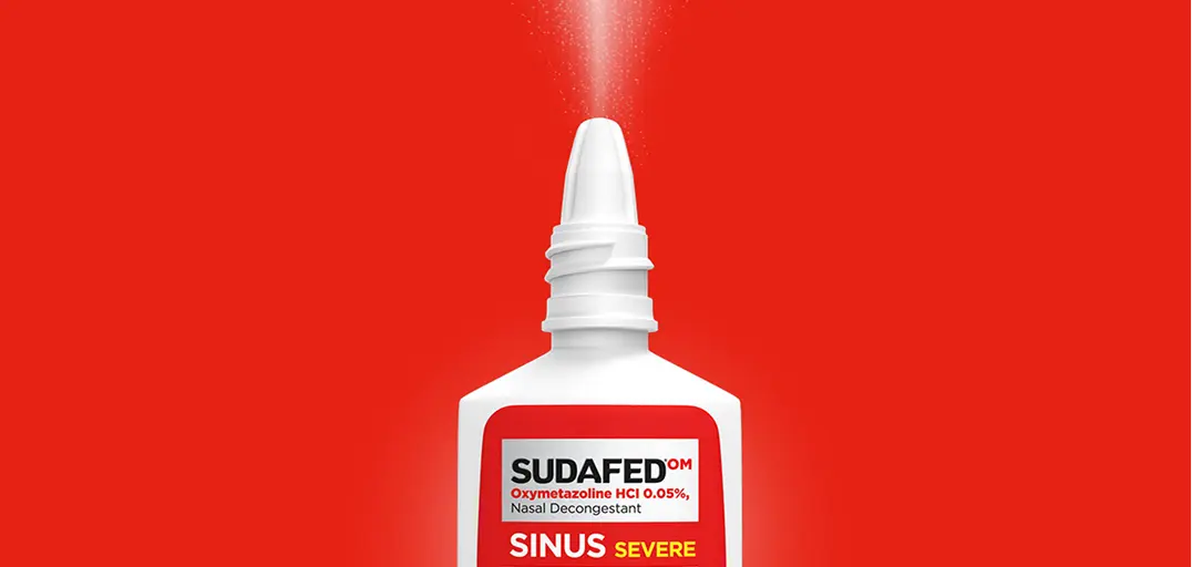 SUDAFED® Sinus Severe Original Nasal Spray Decongestant bottle on a red background