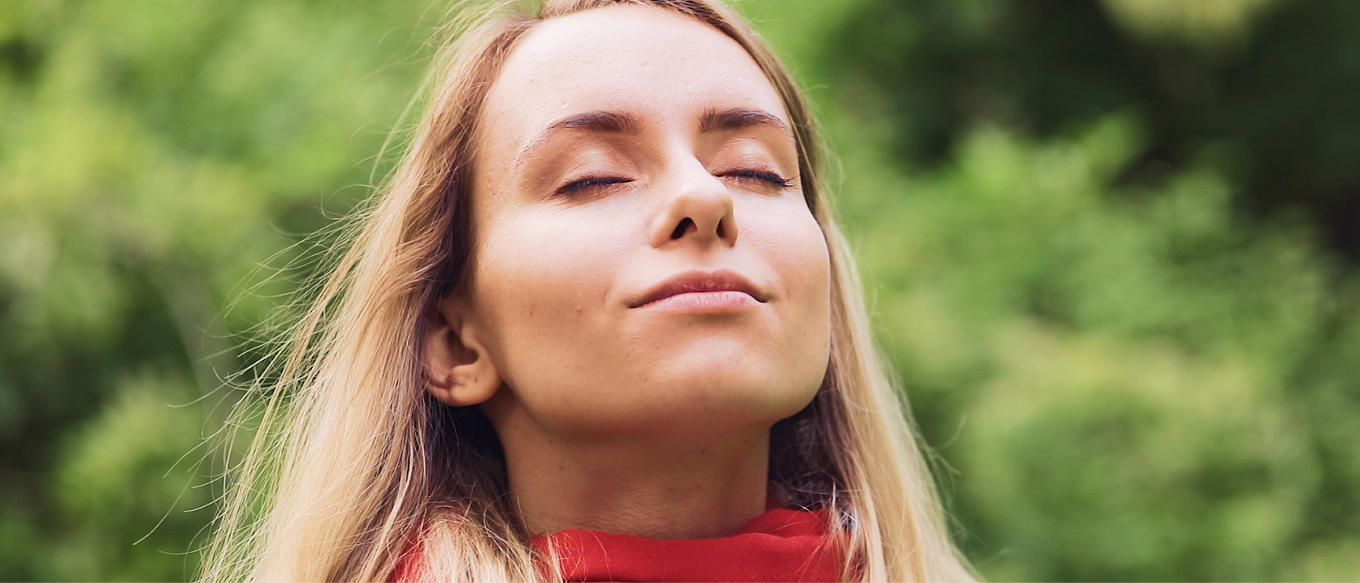 Woman with closed eyes, looking relieved and breathing easily.