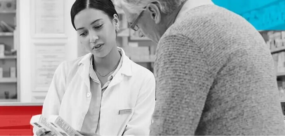 Pharmacist showing older customer medication