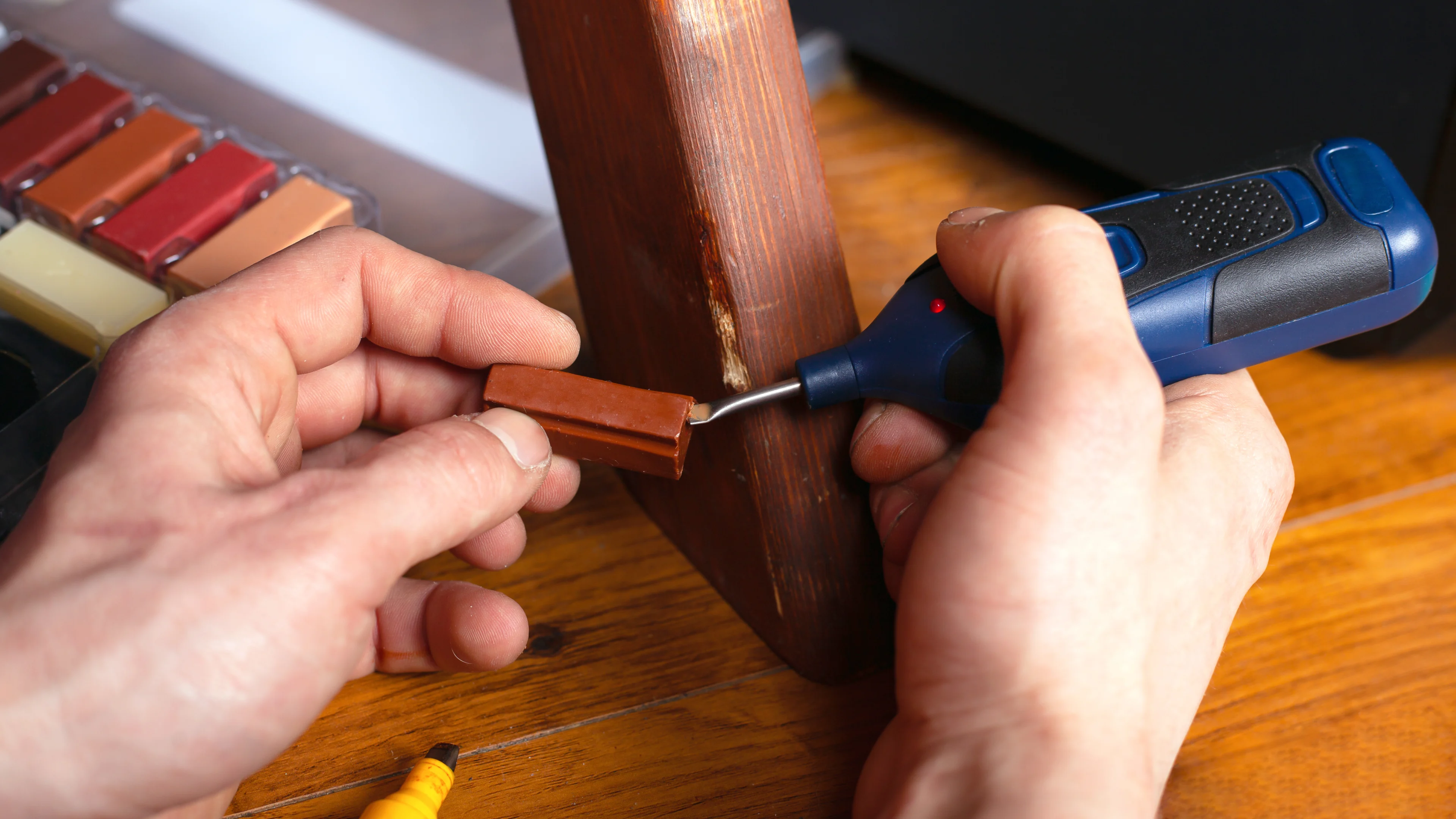 a person repairing a piece of furniture