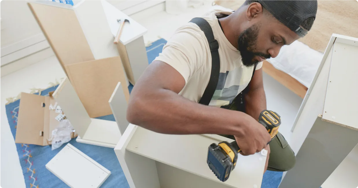 Image of a Tasker assembling furniture