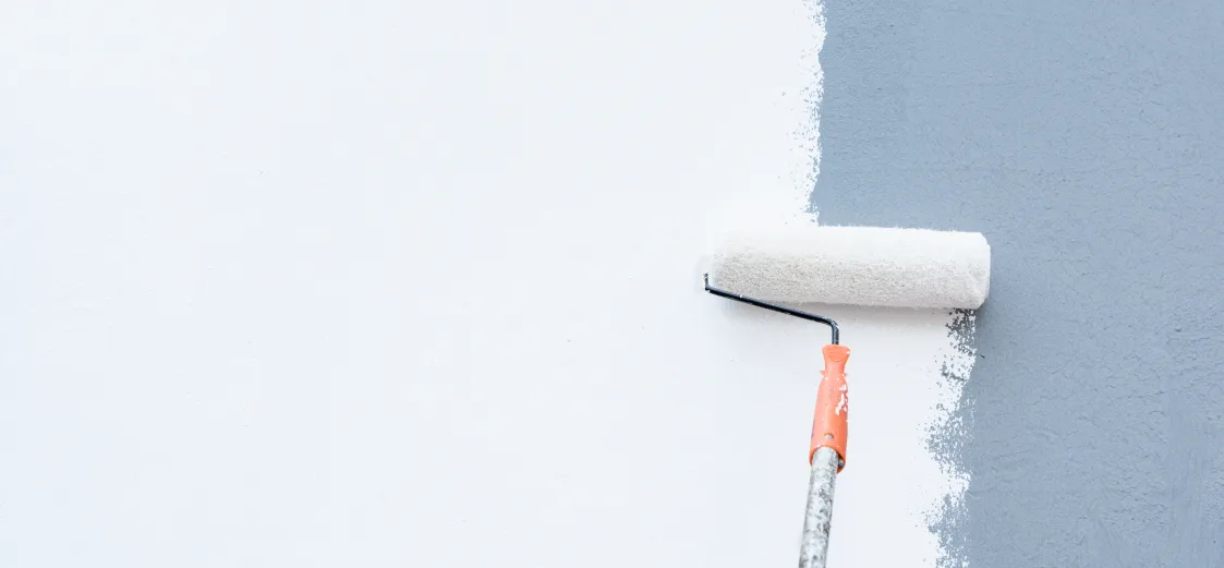 A picture of someone using a paint roller to paint