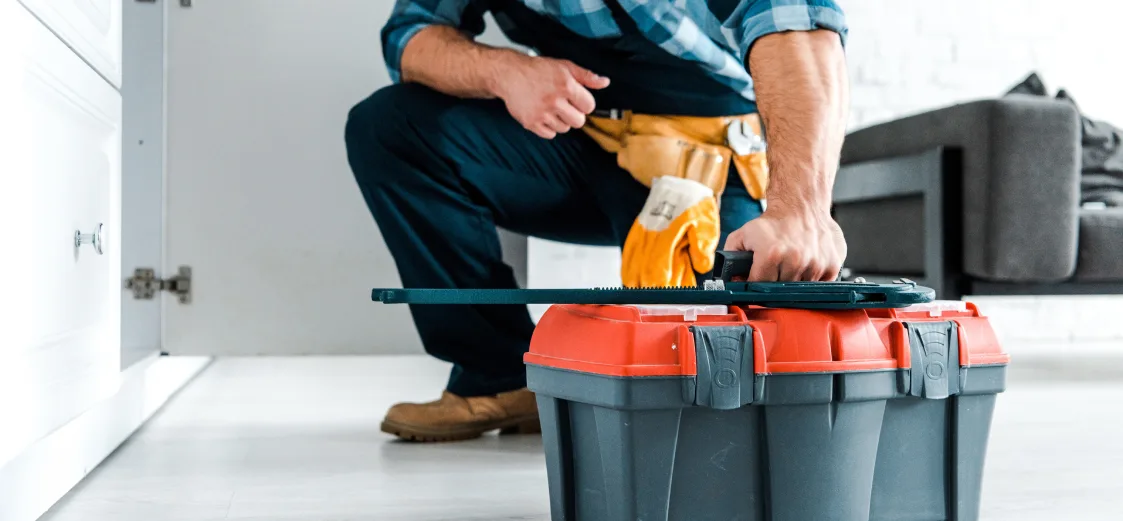 A picture of a handyman with a tool box