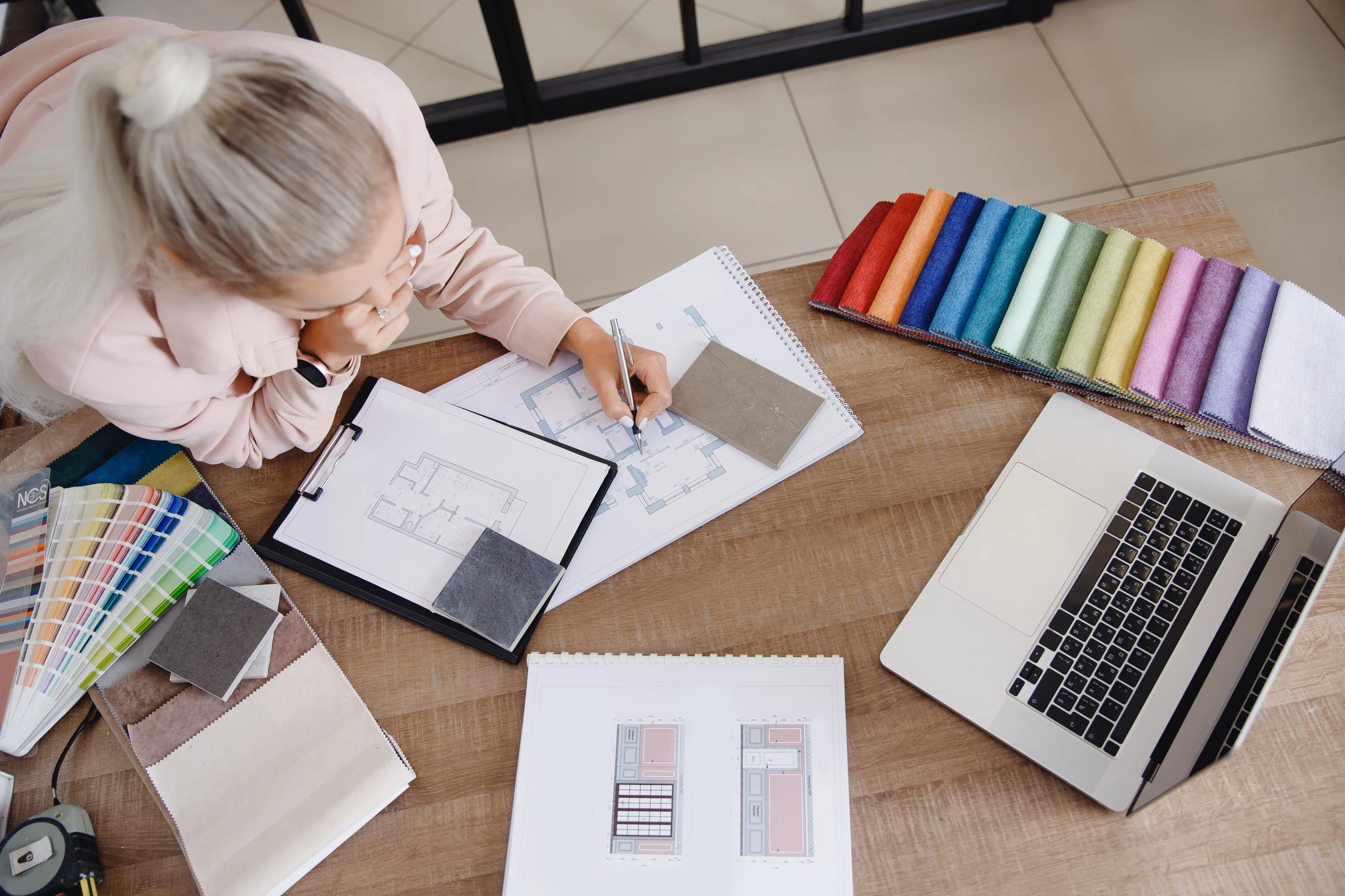 a person drawing sketches of interior designs and room layouts