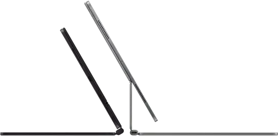 Two Magic Keyboards with iPad Pro attached shown back to back in Space Black and Silver finishes