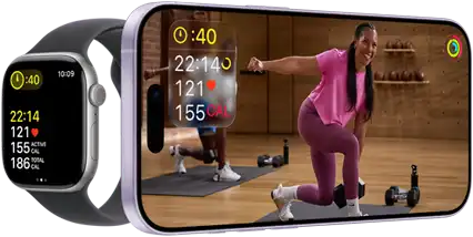 Apple Watch next to iPhone with Apple Fitness+ class on screen