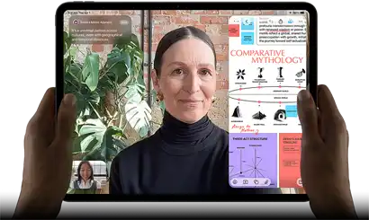 iPad Pro, front exterior, landscape orientation, space black colour, rounded corners, black display bezel, hands holding left and right sides, display showing a FaceTime conversation being live translated, and an educational app showing a presentation of "Comparative Mythology" with text, diagrams and handwritten notes