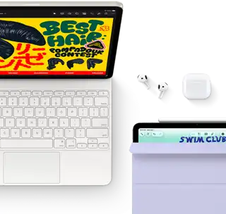 iPad Air, Starlight colour, colourful graphics on screen, attached to Magic Keyboard, AirPods Pro and Apple Pencil Pro accessories