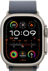 Apple Watch Ultra 2 shown attached to blue Alpine Loop, displaying watch face with complications including GPS, temperature, compass, altitude and fitness metrics