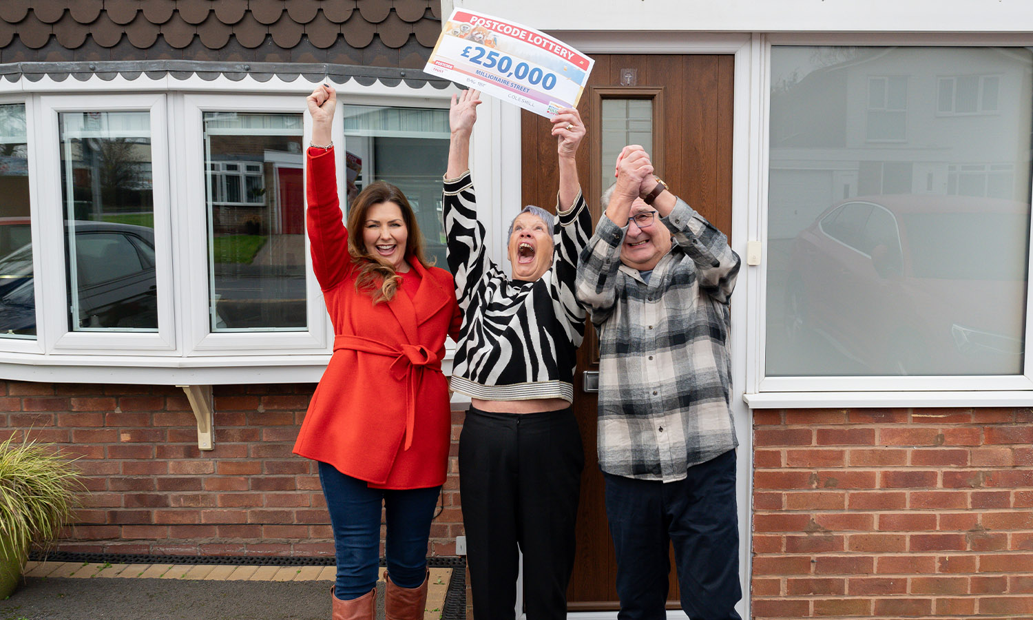 CHEQUE IT OUT: Judie celebrates with Bev and Andy