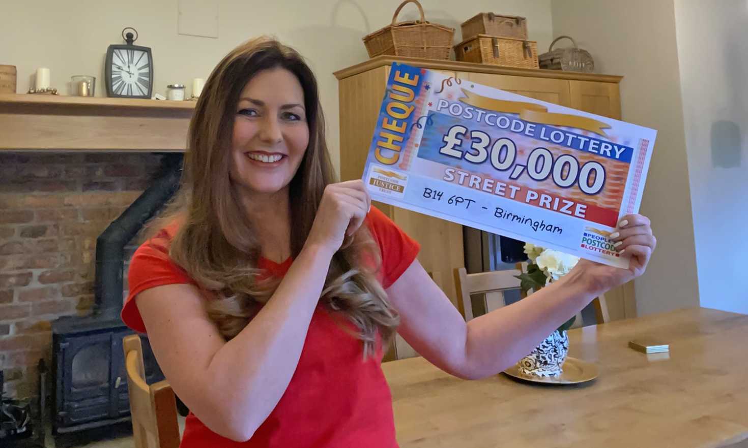 Judie has a fabulous £30,000 cheque for each of our lucky winners in Birmingham