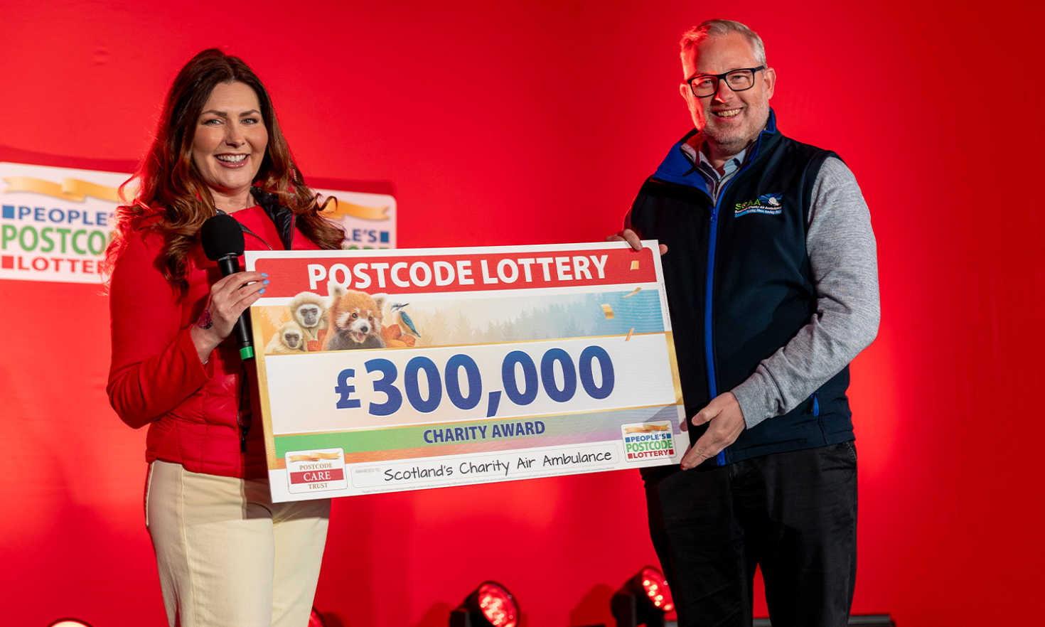 Air We Go: David Craig, chief executive of Scotland's Charity Air Ambulance, being presented with a bumper cheque by Judie McCourt at our latest Postcode Millions event in Perth