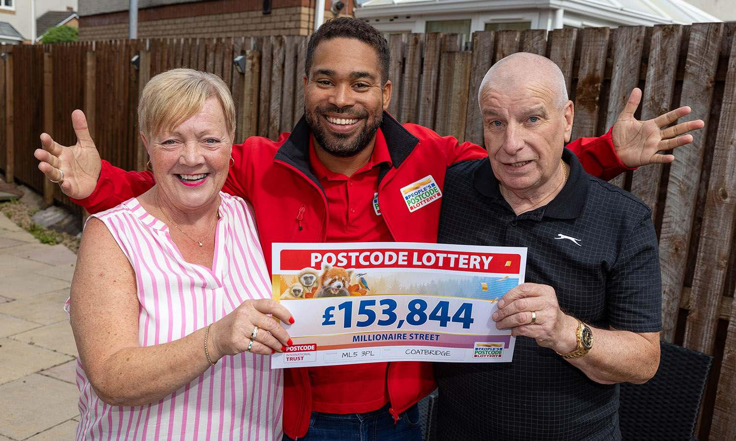 MAY THE FOURS BE WITH YOU: Geraldine and hubby Paul with lottery presenter Danyl Johnson