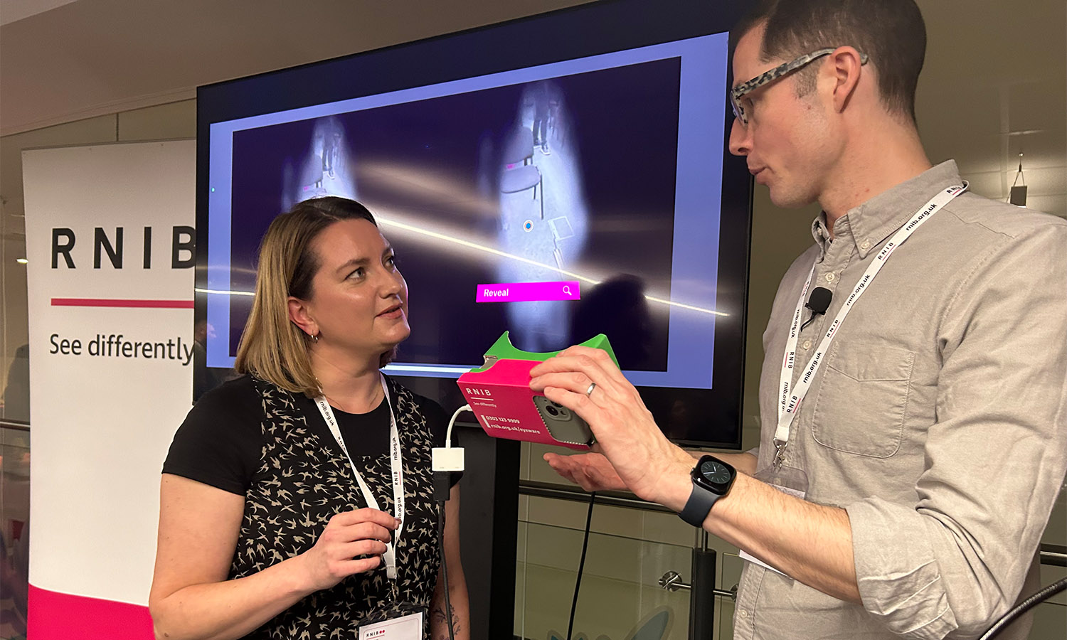 Making a difference: RNIB's Jim Sanders demonstrates Eyeware to Hazel Johnstone, Long-term Partnerships Manager at People's Postcode Lottery