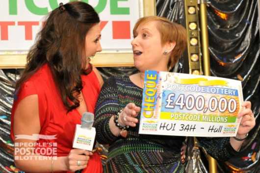 Judie McCourt with lucky winner Elaine Lamping and her £400,000 cheque
