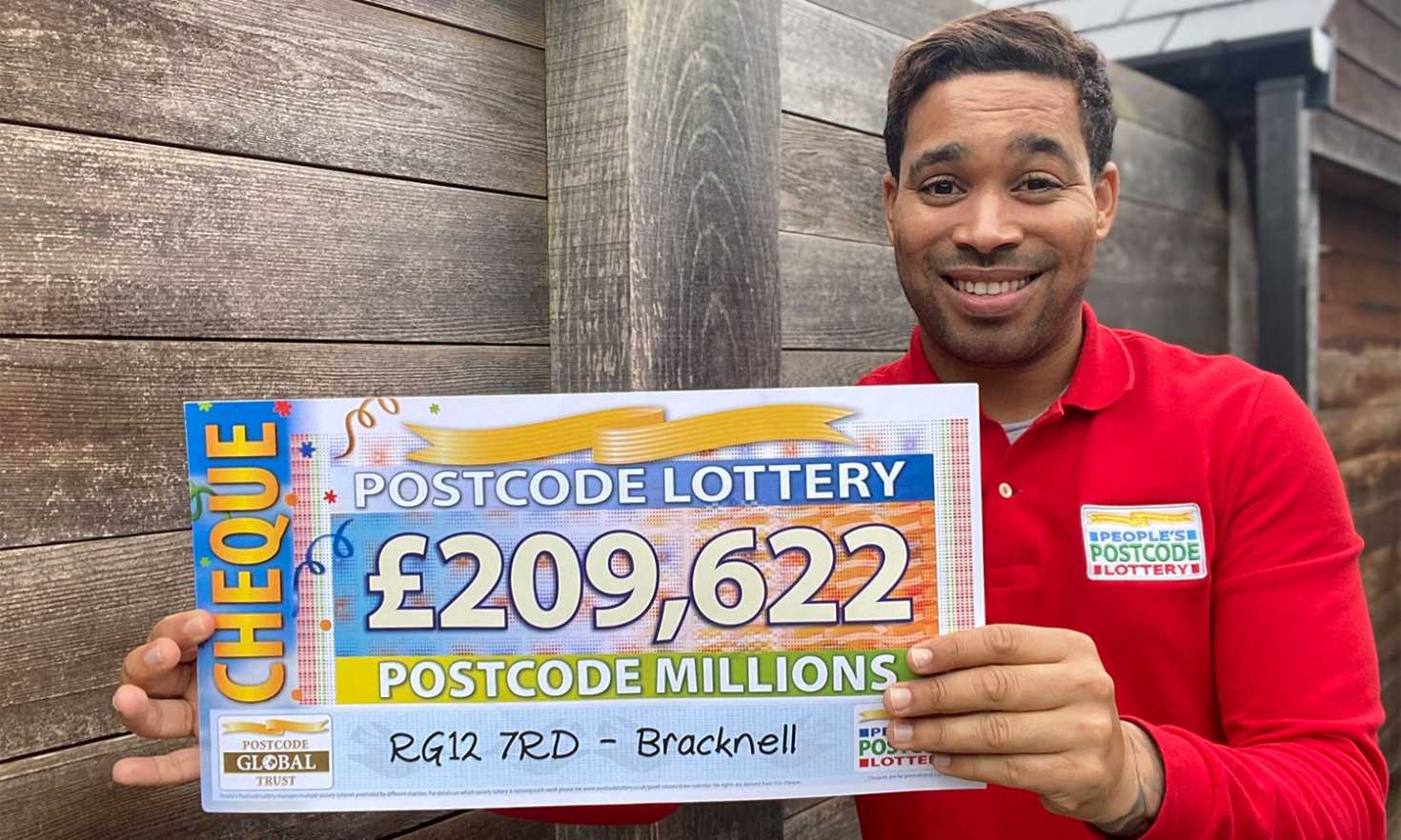 Danyl holds up one of our big winner cheques from today's Postcode Millions