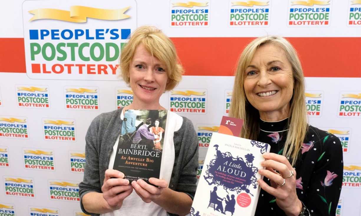 Actor Claire Skinner and our Ambassador Fiona Phillips holding books at a special Shared Reading event in Liverpool