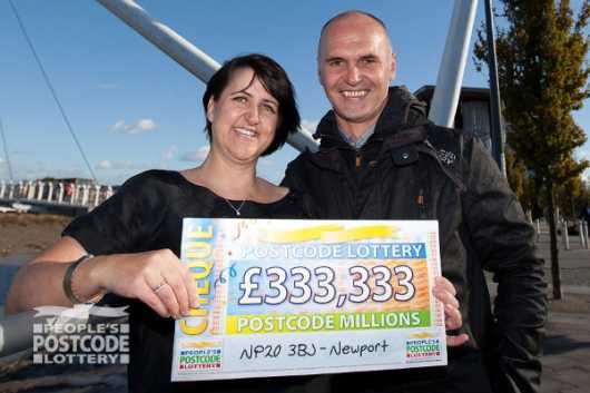 Winner Jacqui Howell and husband Dave with their £333,333 cheque