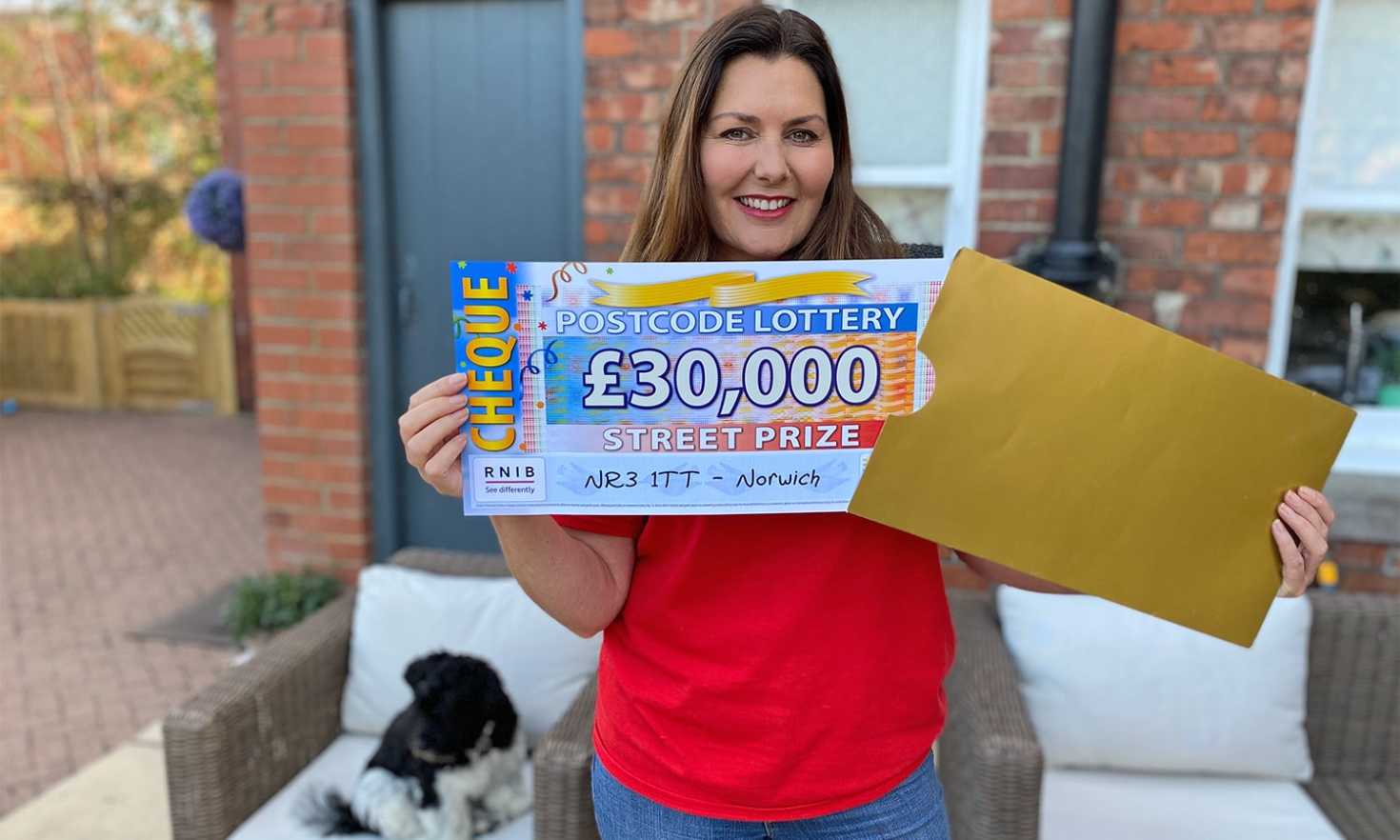 Judie has a terrific £30,000 cheque for each of our lucky winners in Norwich