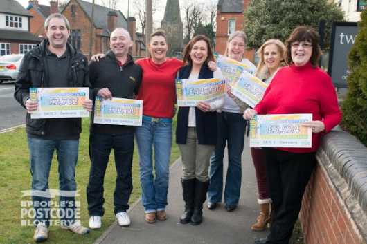 Postcode Lottery Ambassador Judie McCourt with our lucky Derbyshire winners and their cheques