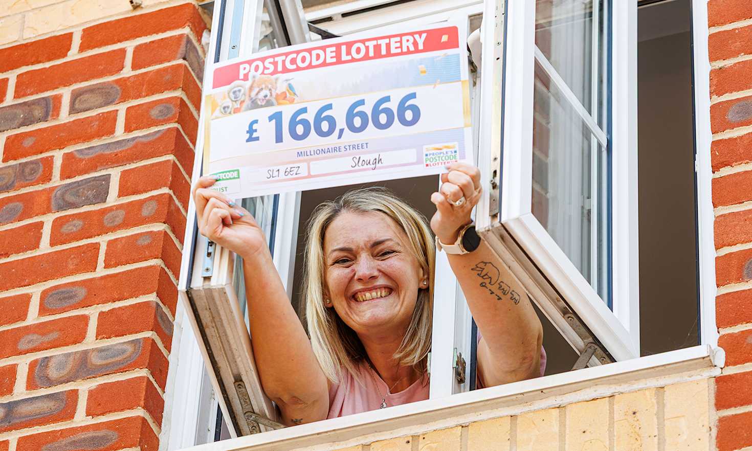 Nikki waves her cheque from her apartment window Nikki waves her cheque from her apartment window