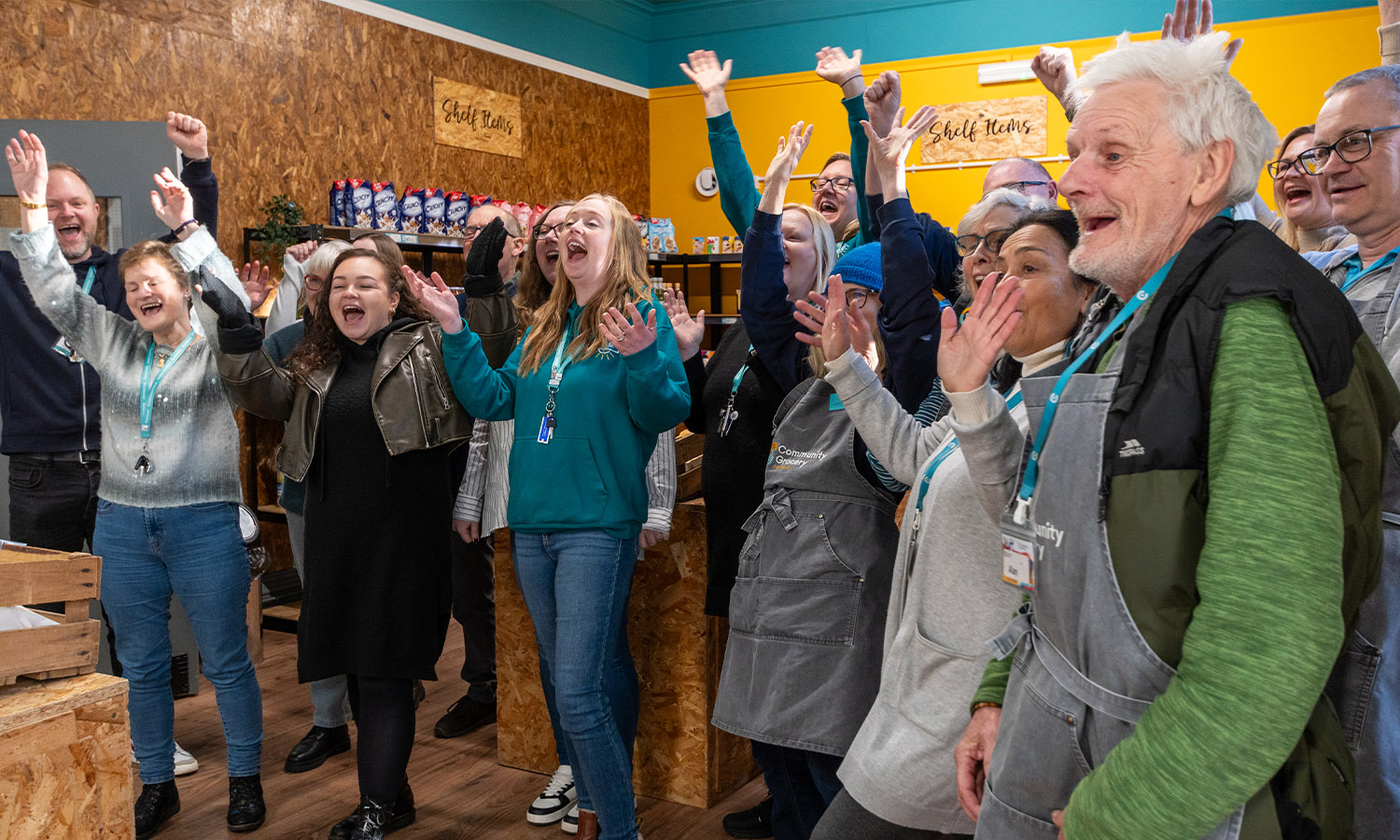 FRUITFUL FUNDING: Staff and volunteers of Community Grocery shop cheer at £75k boost