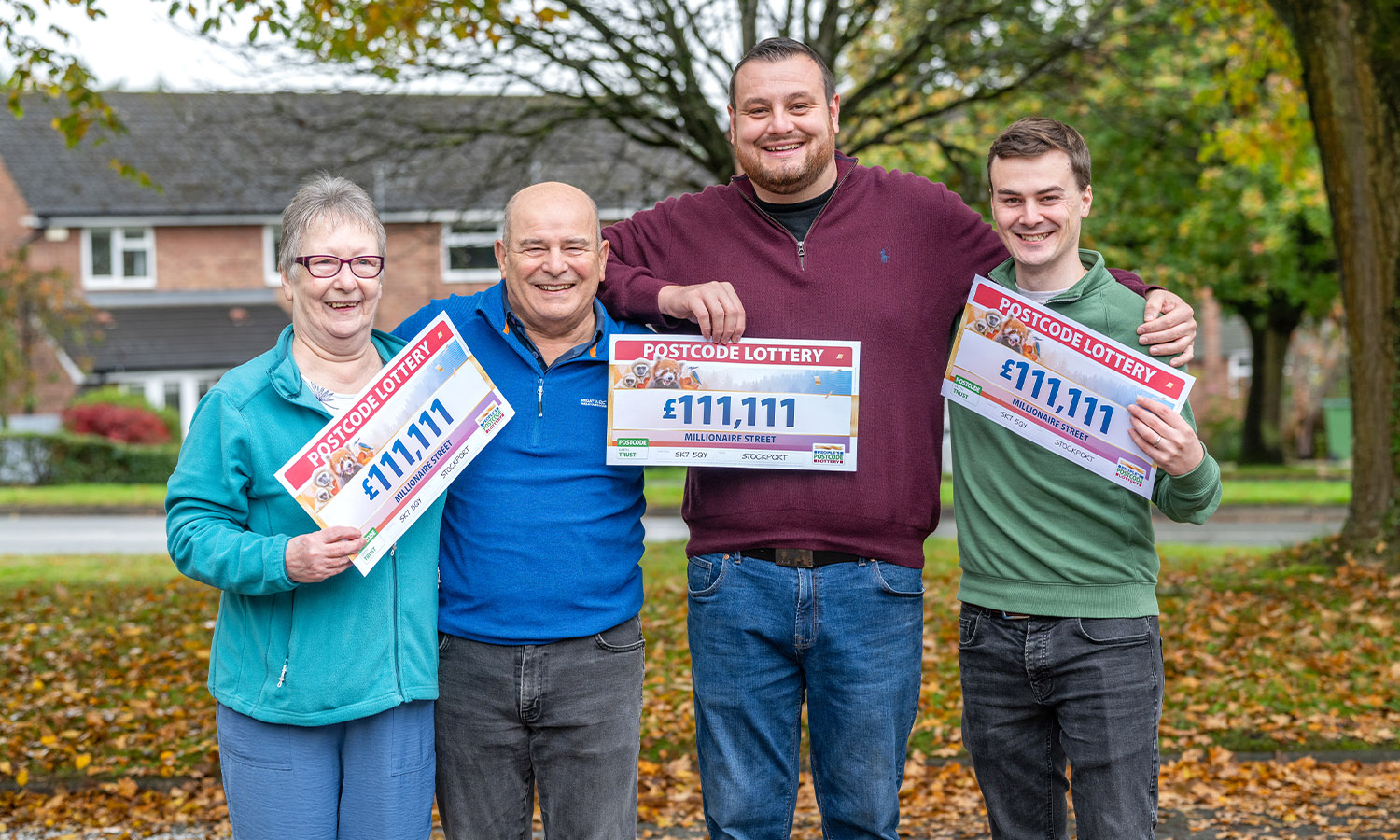 ONES FOR ALL: Gleeful neighbours show off their £111,111 cheques