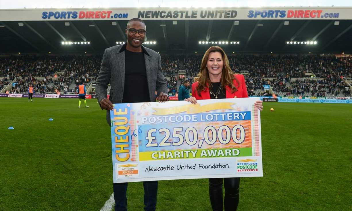 Judie McCourt was joined on the St. James' Park pitch by Newcastle United Foundation patron Shola Ameobi
