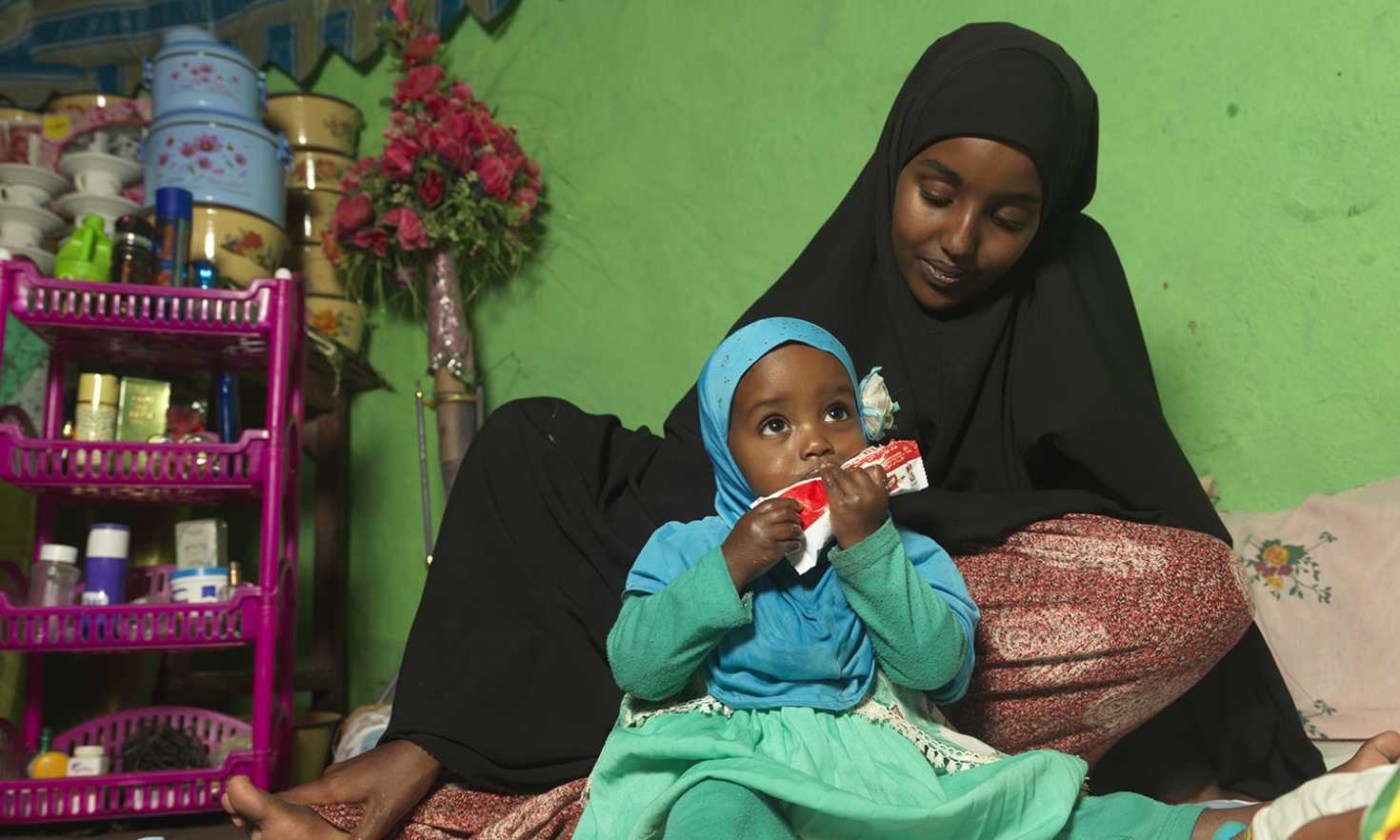 Medina with baby Munira (Photo credit: Peter Caton for Action Against Hunger)