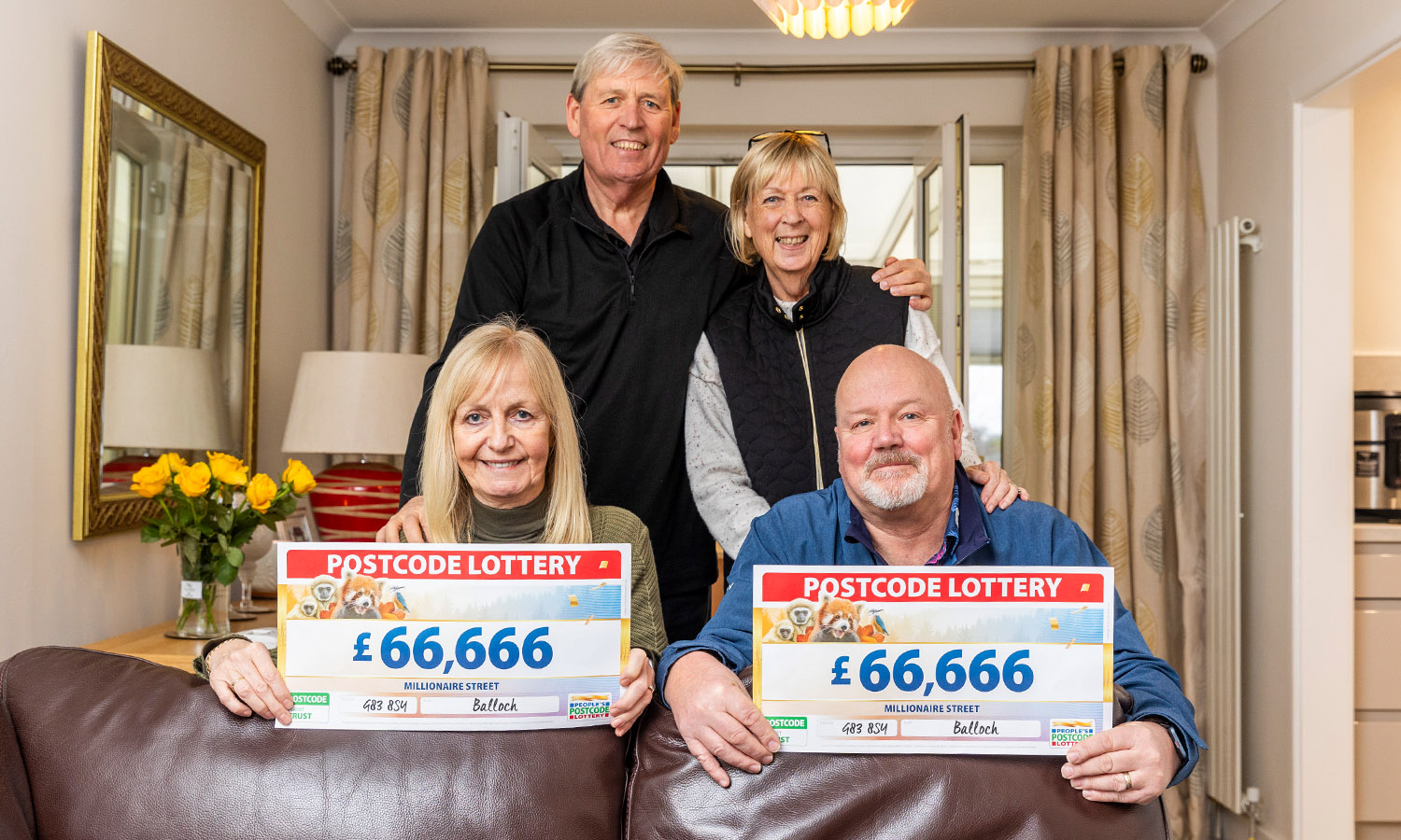 FAMILY FORTUNES: Paul and Kay hold cheques with their siblings Alex and Catherine