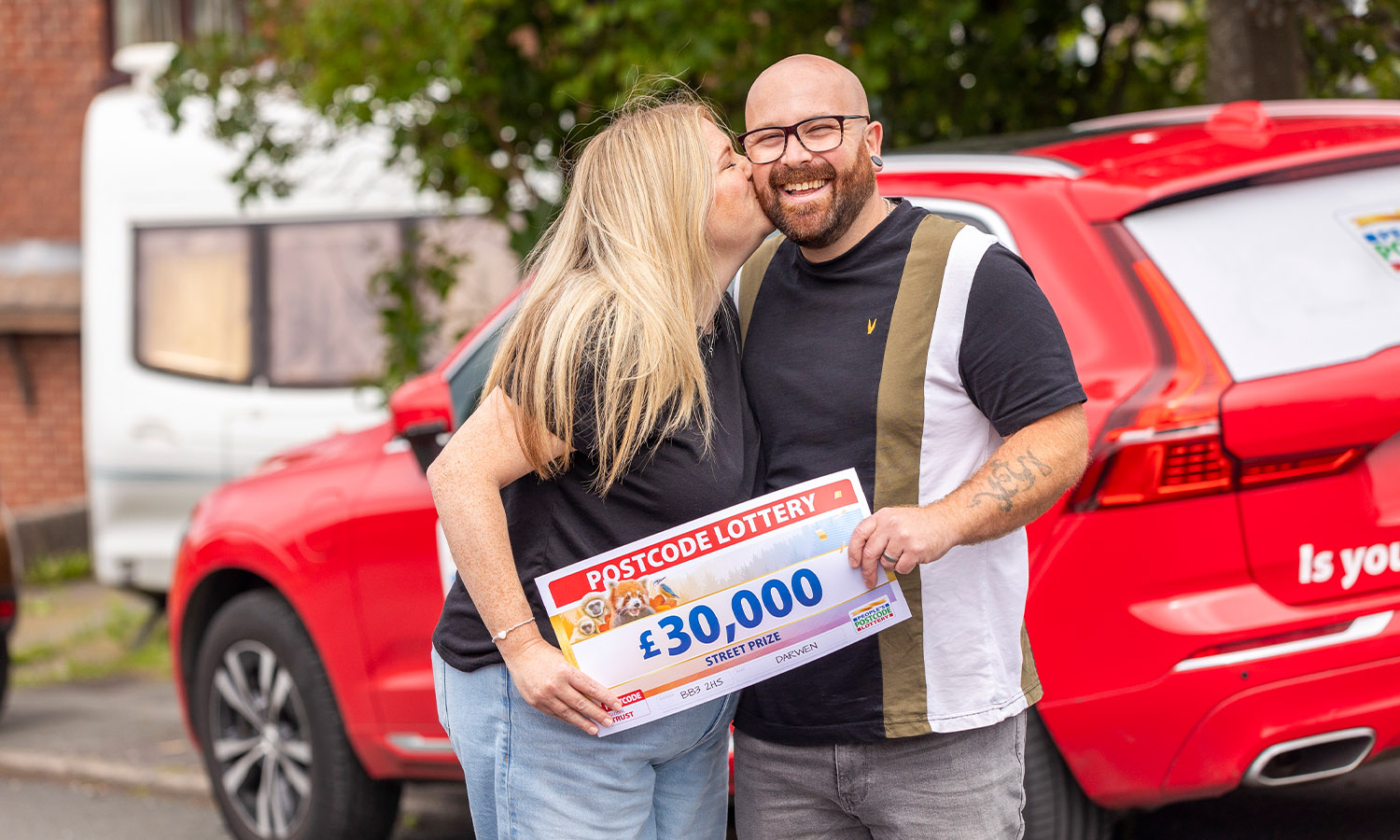 THIRTY THOUSAND SMACKERS: Mark gets a kiss from Michaela after receiving his cheque