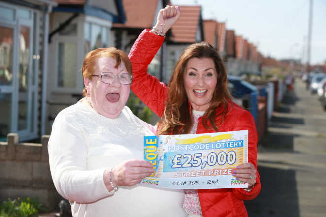 Judie McCourt with lucky winner Mary and her whopping £25,000 cheque