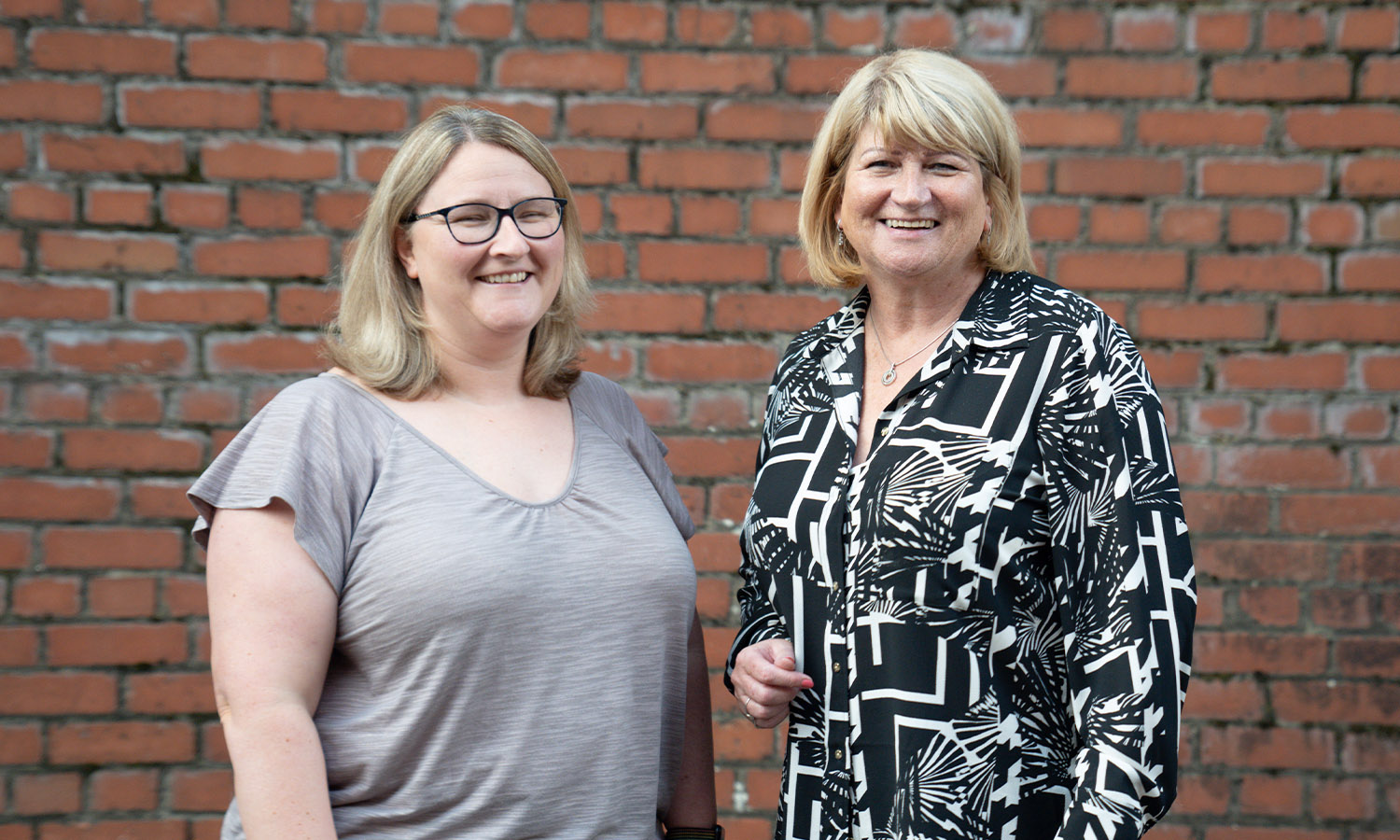 CHARITY NEIGHBOURS: Delighted Sylvia McPhillips of Deaf Services Lanarkshire (left), and Marian Tobin of Coatbridge CAB (right)