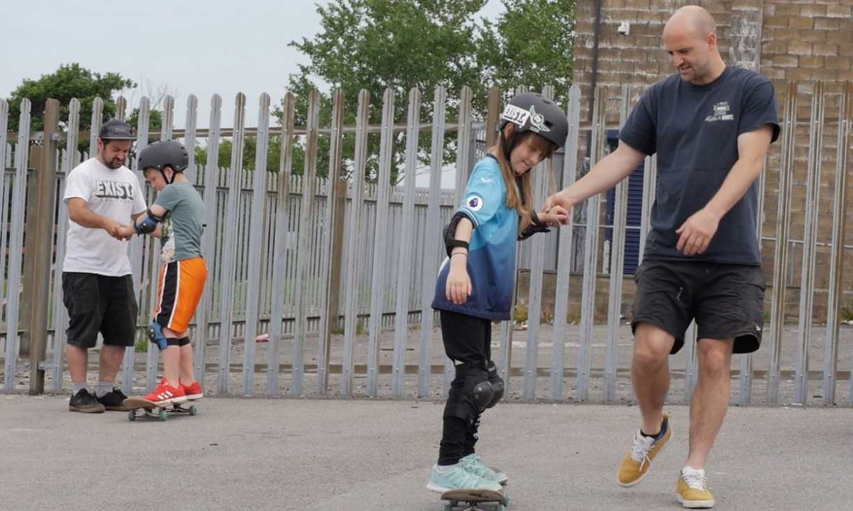 Coaches teach young people how to skate at a CUSP Swansea skate park