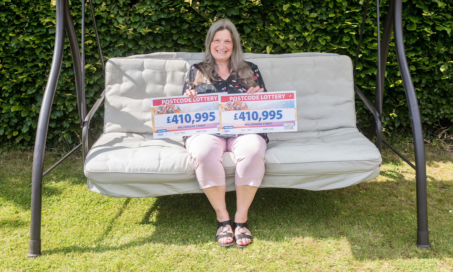 SWING WHEN YOU'RE WINNING: Sally celebrates prize in sun-kissed back garden