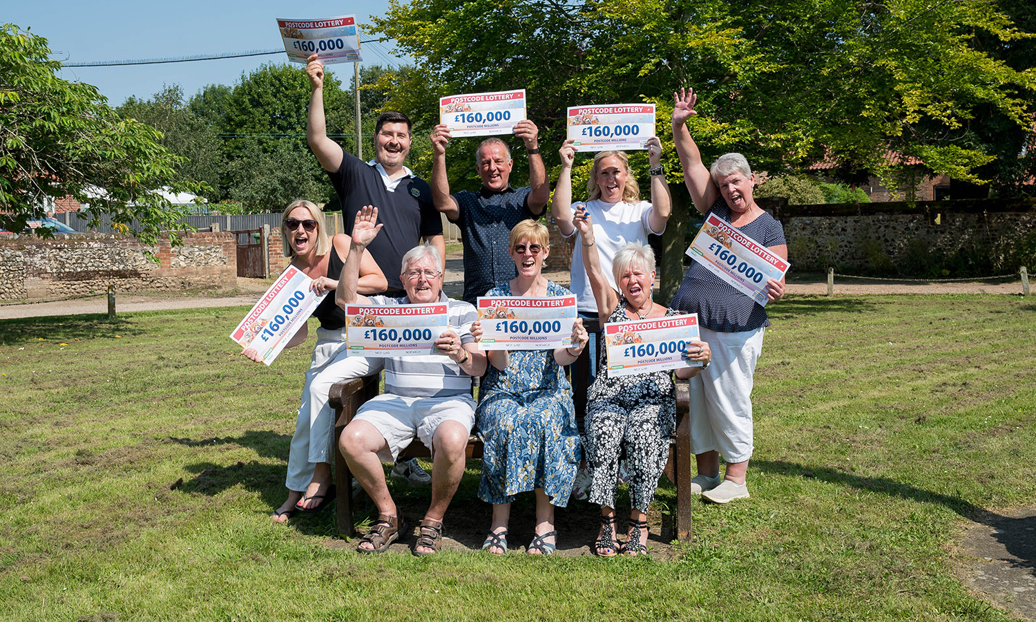 CHEQUE US OUT!: Villagers pose before starting celebrations