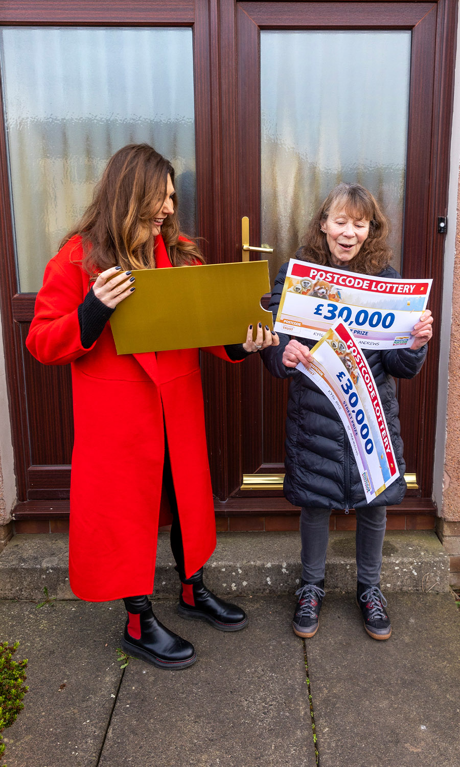 DOING THE DOUBLE: Judie gives Carol two cheques