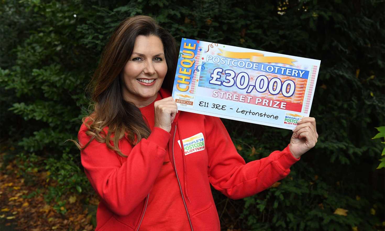 Judie reveals a fabulous £30,000 cheque for each of our lucky winners in Leytonstone