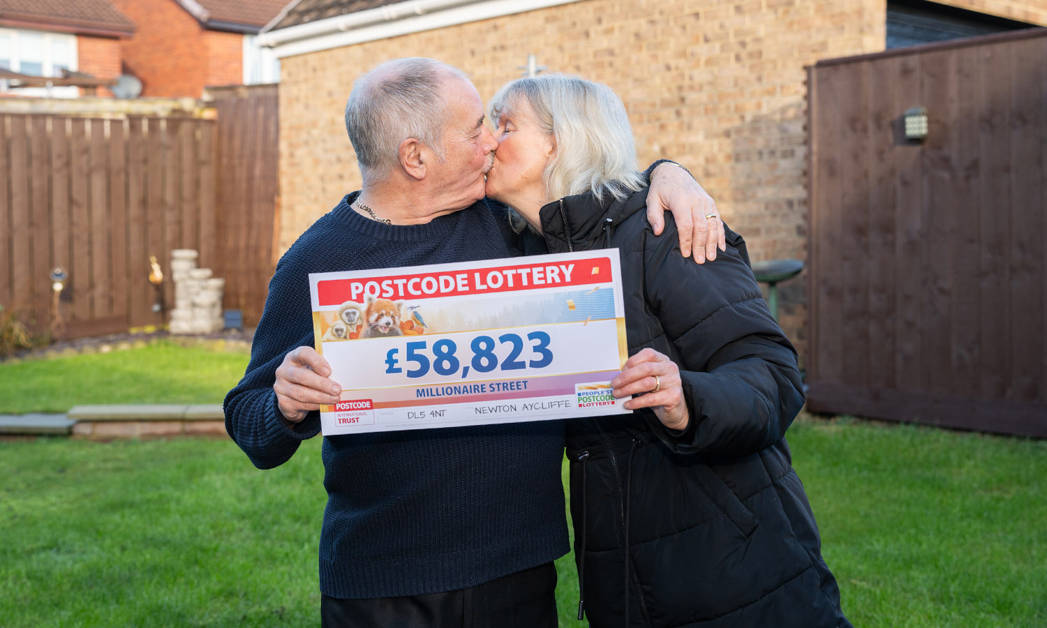 LUCKY IN LOVE: David and Pat Coglan seal their win with a kiss