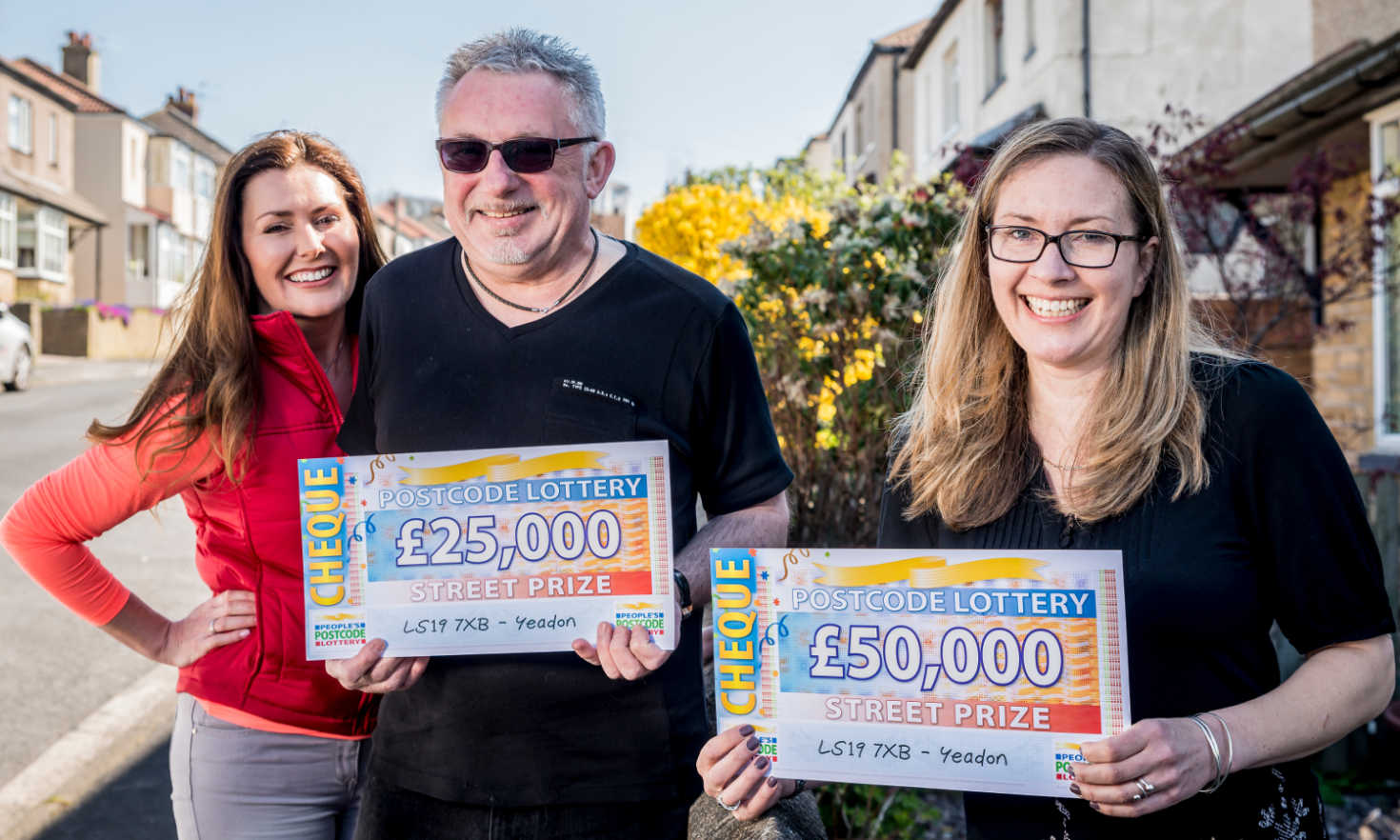 People's Postcode Lottery ambassador Judie with lucky Street Prize winners David and Lisa