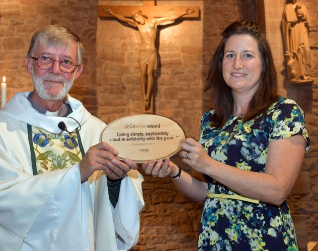 Father Iain Griffiths receives the ‘Live Simply Award’ from local councillor Julie Buckley at St John the Evangelist's church in Bridgnorth, Shrewsbury Diocese.