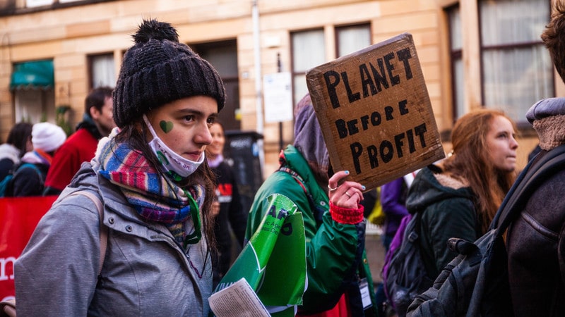 UK - Glasgow - COP26 Global Day of Action - Planet before profit placard