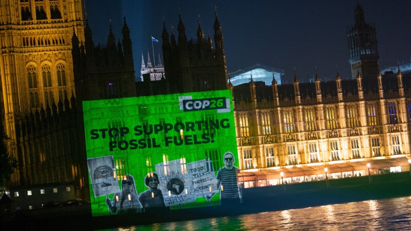 UK - Westminster - COP26 projection onto Parliament stop supporting fossil fuels