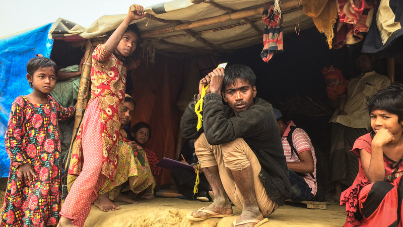 Asia - Bangladesh - Rohingya camp - man and children in poor housing