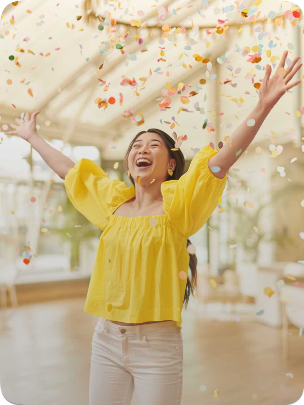 Woman in yellow celebrating Livat