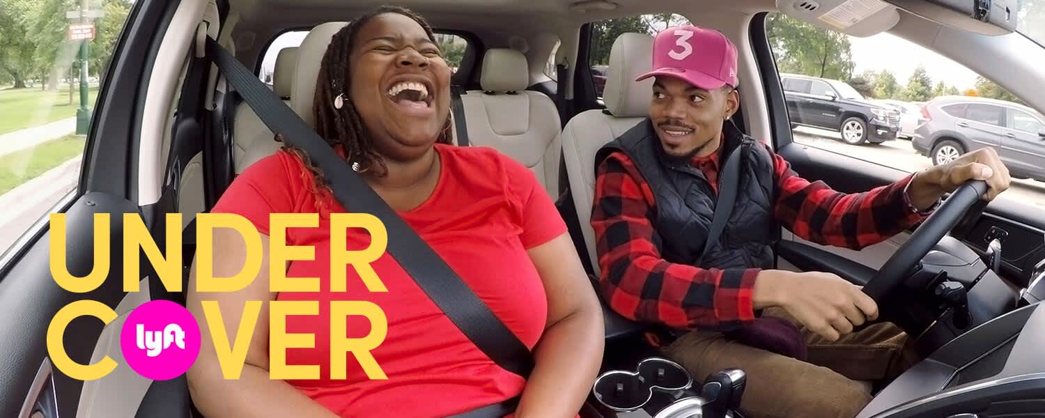 Chance the Rapper laughing with a rider while driving with Lyft.