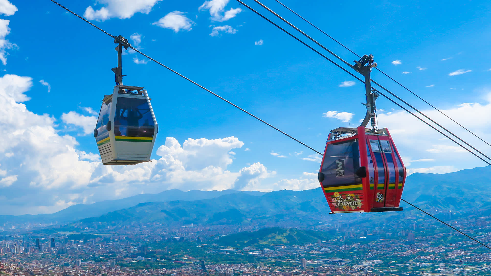 Cable cars of the Metrocable, a gondola system that links the city with the neighborhoods and suburbs in the mountains in Medellín, Colombia. (Photo by EyesWideOpen/Getty Images)