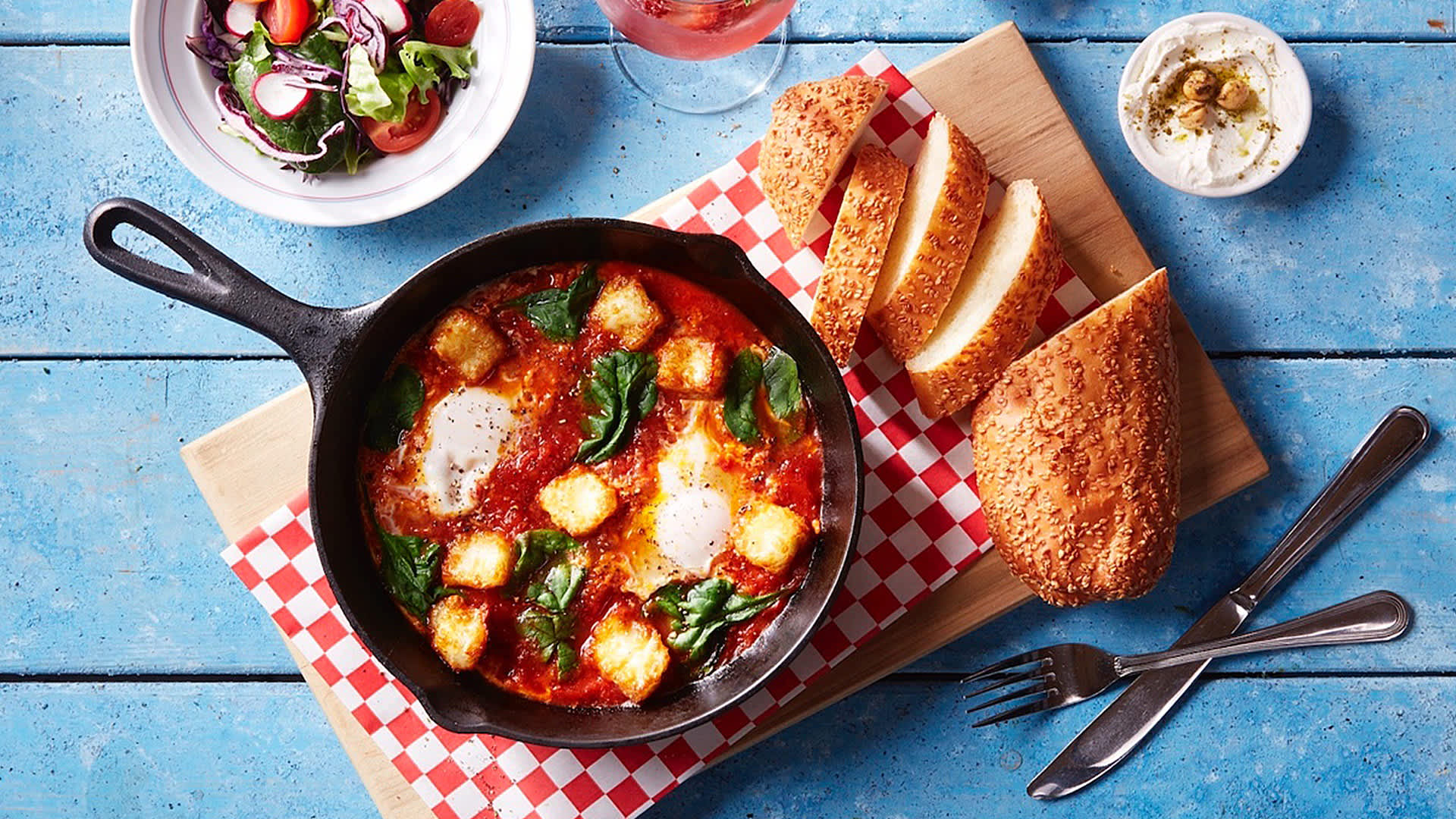 Landwer's classic shakshuka with spinach and deep-fried halloumi cheese. Served with side salad, tahini, and a choice of bread. Served with eggs medium-hard.